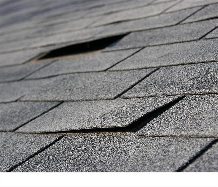 Residential roof with missing shingles