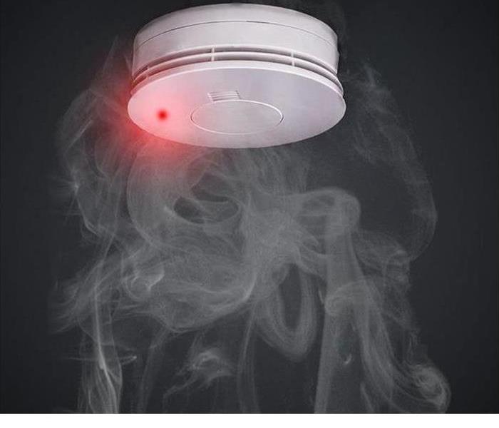 Picture of smoke detector with smoke visible