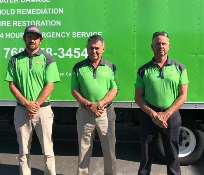 Owners in front of SERVPRO truck